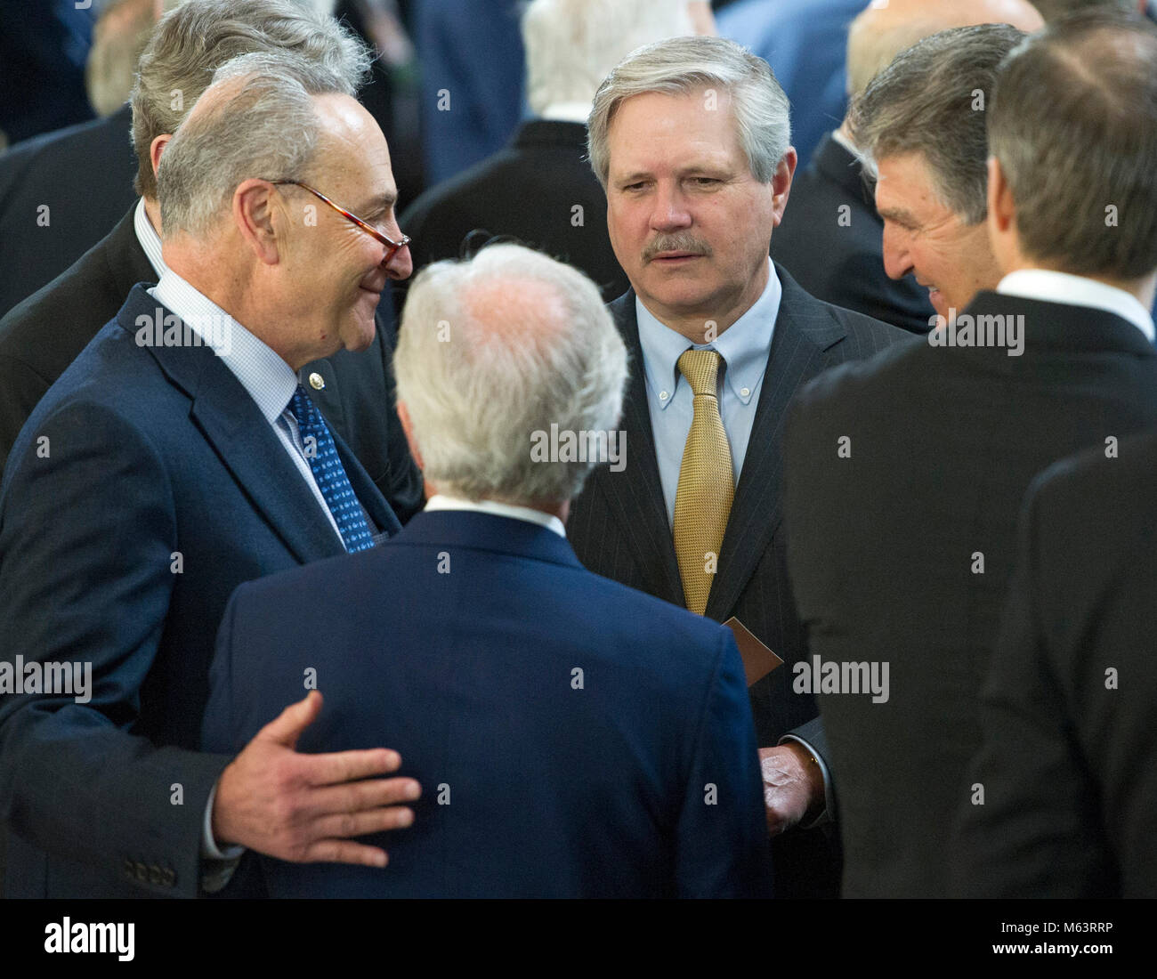 Washington, United States Of America. 28th Feb, 2018. United States Senate Minority Leader Chuck Schumer (Democrat of New York), left, speaks with US Senator John Hoeven (Republican of North Dakota), upper center, US Senator Joe Minchin (Democrat of West Virginia), right, and US Senator Bob Corker (Republican of Tennessee), lower center left, in the US Capitol Rotunda prior to the arrival ceremony preceding the lying in honor of the Reverend Billy Graham in Washington, DC on Wednesday, February 28, 2018. Credit: Ron Sachs/Pool via CNP Photo via Credit: Newscom/Alamy Live News Stock Photo
