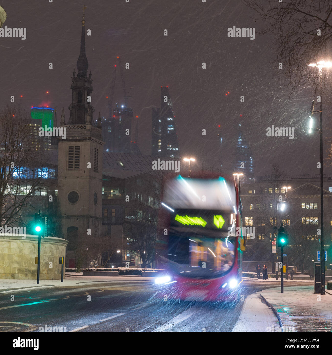 London, England, UK. 28th Feb, 2018. UK Weather: A double-decker bus battles through the 'Beast From The East' snowstorm amongst the buildings of the City of London. Credit: Joe Dunckley/Alamy Live News Stock Photo