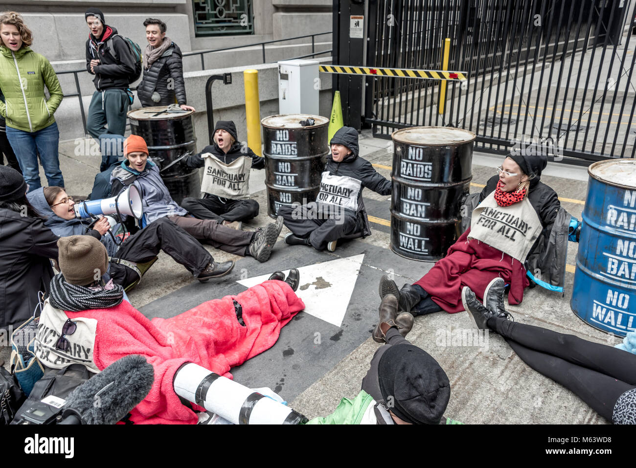 San Francisco, USA. 28th February, 2018. An estimated three hundred protesters gather outside San Francisco Immigration & Customs Enforcement building (ICE) to protest recent arrests of at least 150 people in ICE operations conducted over the previous few days in Northern California. San Francisco remains a sanctuary city. Shelly Rivoli/Alamy Live News Stock Photo