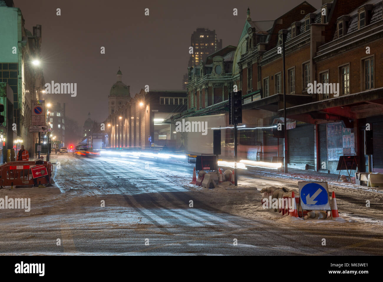 London, England, UK. 28th Feb, 2018. UK Weather: Traffic creates trails in snow falling on Farringdon Street outside Smithfield Market during the 'Beast From The East' snowstorm in London. Credit: Joe Dunckley/Alamy Live News Stock Photo