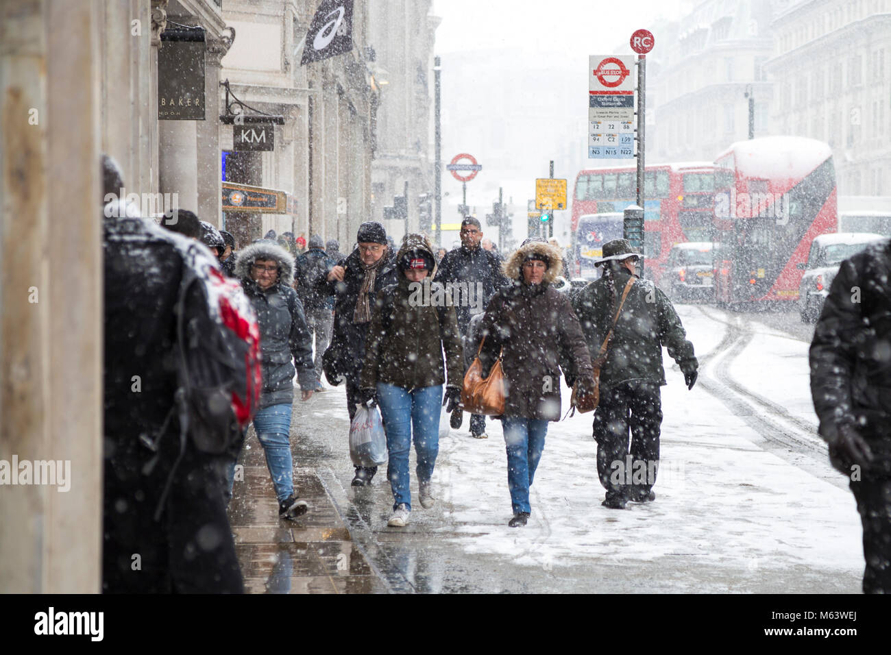 London, UK. 28th Feb, 2018. UK Weather: Heavy snow caused severe early delays for millions of London commuters, people walking around the centre of the capital shielding from snow Credit: Nathaniel Noir/Alamy Live News Stock Photo