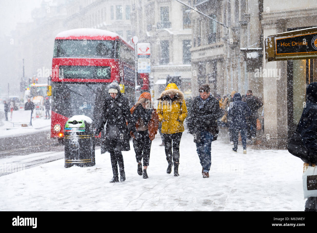 London, UK. 28th Feb, 2018. UK Weather: Heavy snow caused severe early delays for millions of London commuters, people walking around the centre of the capital shielding from snow Credit: Nathaniel Noir/Alamy Live News Stock Photo