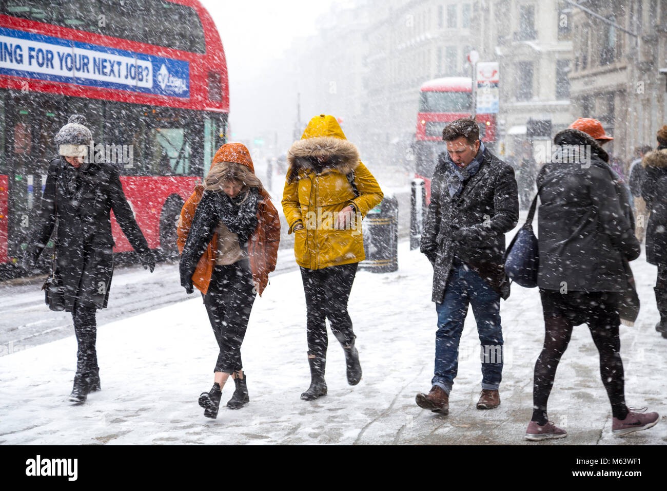 London, UK. 28th Feb, 2018. UK Weather: Heavy snow caused severe early delays for millions of London commuters, people walking around the centre of the capital (Regent Street, Oxford Circus) shielding from wind and snow Credit: Nathaniel Noir/Alamy Live News Stock Photo