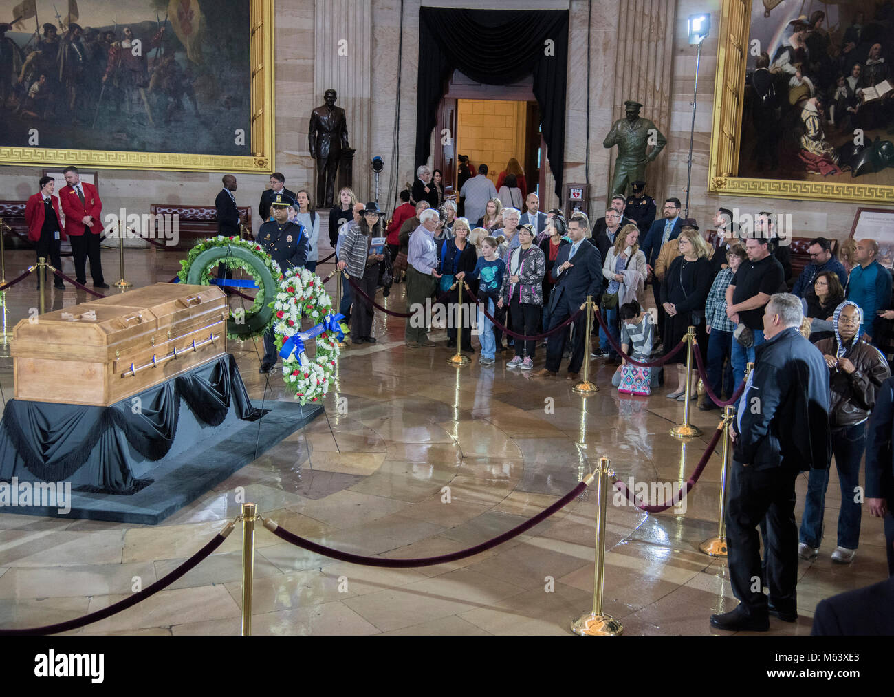 Washington, DC February 28, 2018, USA: An elevated view at the US Capitol Rotunda shows the public paying tribute as the body of Rev Billy Graham 'Lays in Honor' in the Rotunda of the US Capitol. One woman is overcome with grief while viewing the coffin, Patsy Lynch/MediaPunch Stock Photo