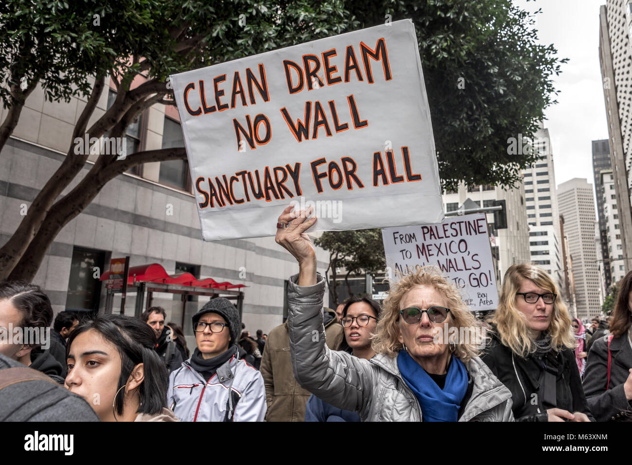 San Francisco, USA. 28th February, 2018. An estimated three hundred protesters gather outside San Francisco Immigration and Customs Enforcement building (ICE) to protest recent arrests of at least 150 people in ICE operations conducted over the previous few days in Northern California. A woman holds a sign reading, 'Clean dream, no wall, sanctuary for all.' San Francisco remains a sanctuary city. Shelly Rivoli/Alamy Live News Stock Photo