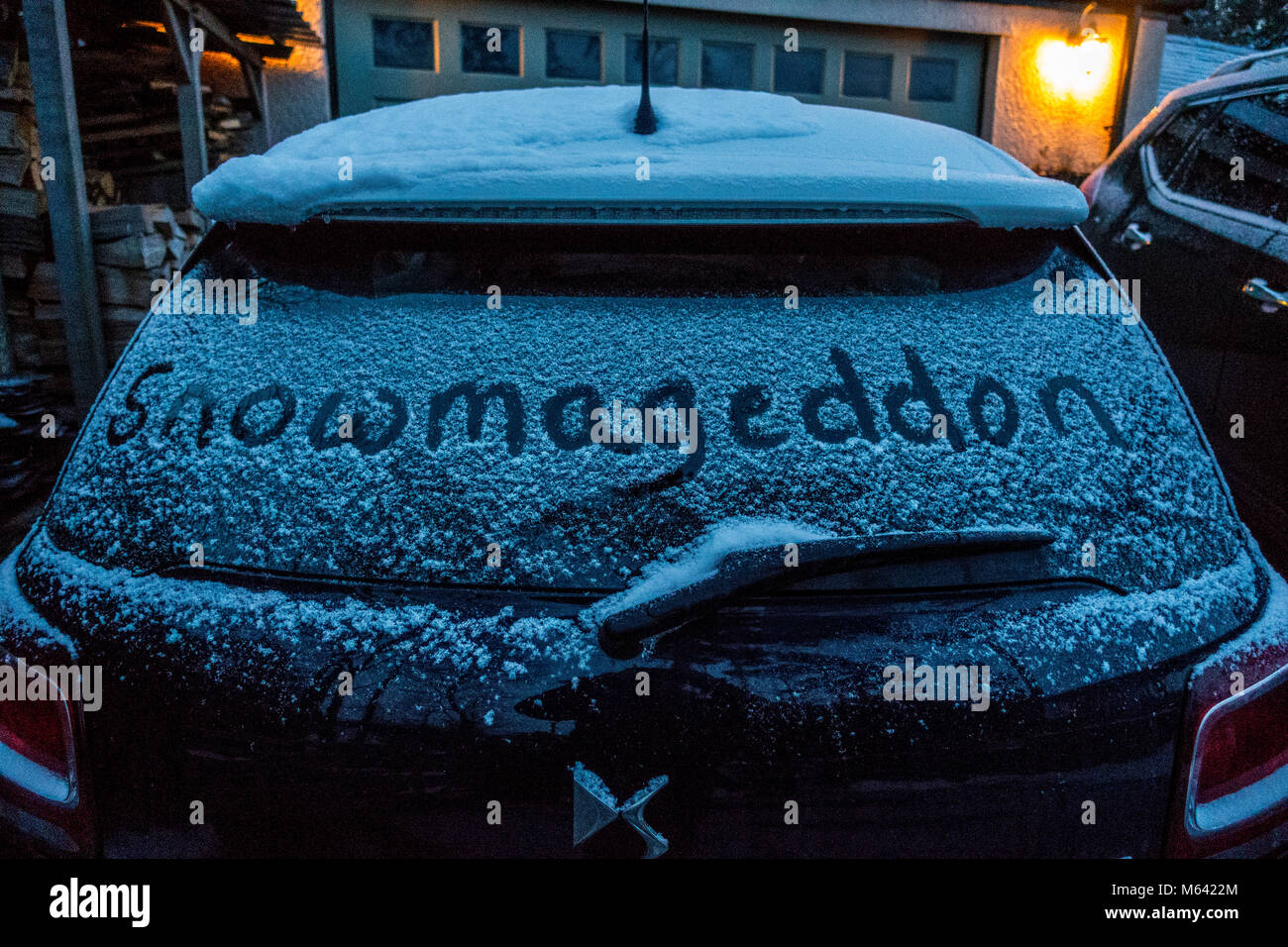 The beast from the East and Storm Emma leaving a dusting of snow on the rear window of a car before the main snow arrives with the words Snowmageddon written into the snow, Wales, UK Stock Photo
