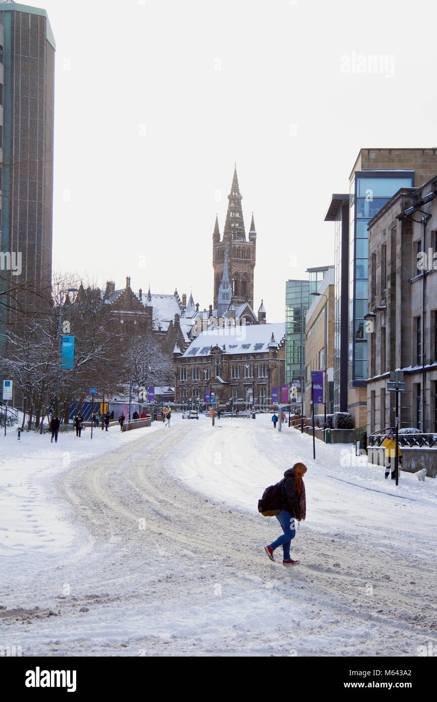 Glasgow, UK. 28th Feb, 2018. UK Weather: People making their way through the snowy University Avenue area in the west end of Glasgow, during a lull in the heavy snow storms hitting Scotland today. Credit: John Bennie/Alamy Live News Stock Photo