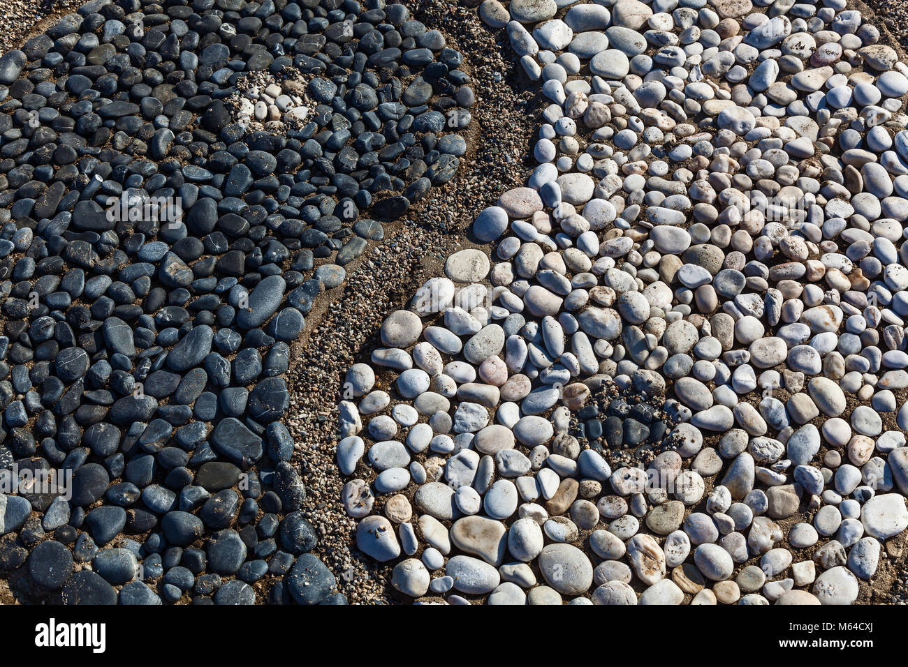 The conception of yin and yang is laid with stones on the sand,Yin and