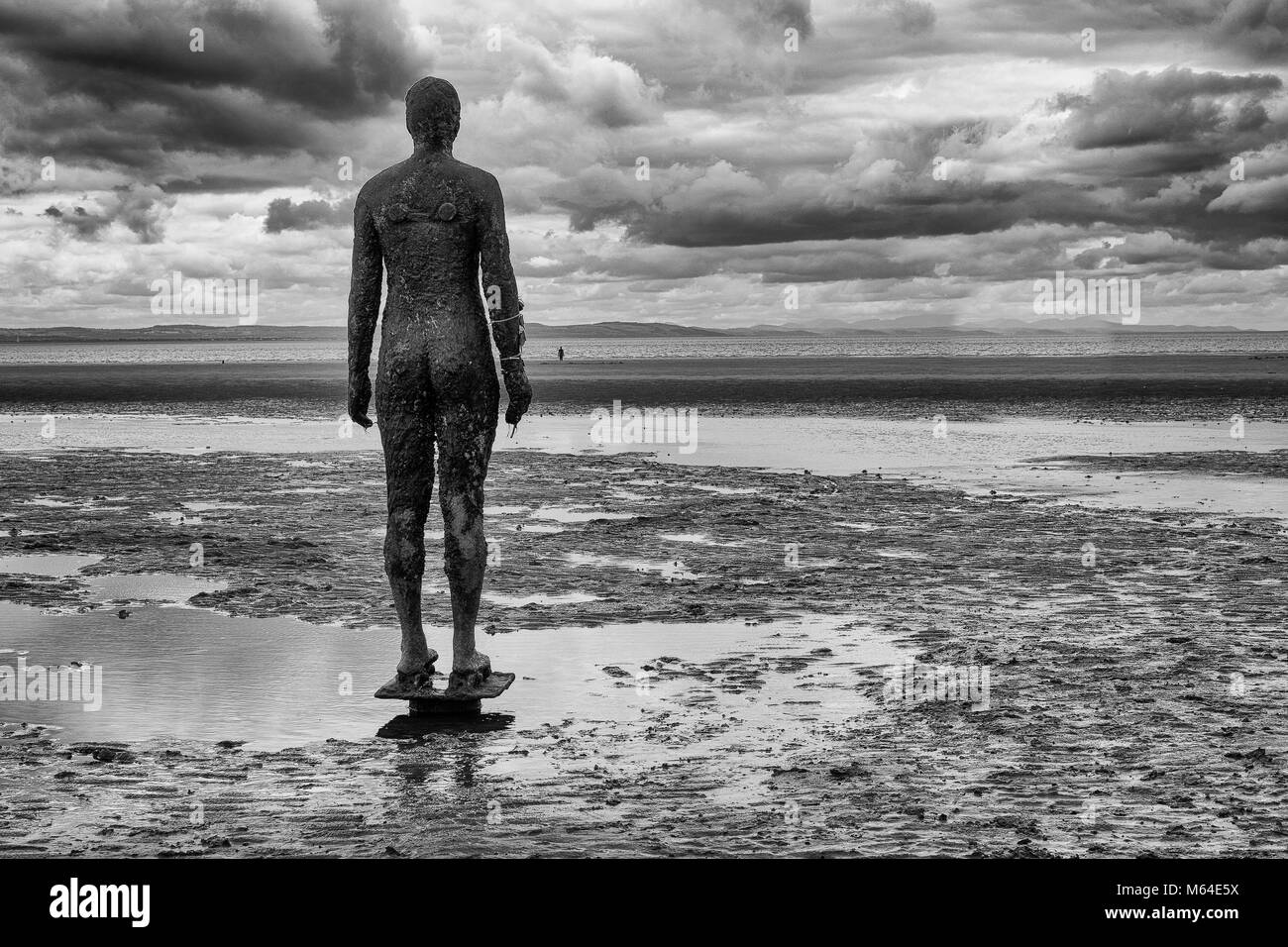 Anthony Gormley's another place at Crosby Beach in Black & White Stock Photo