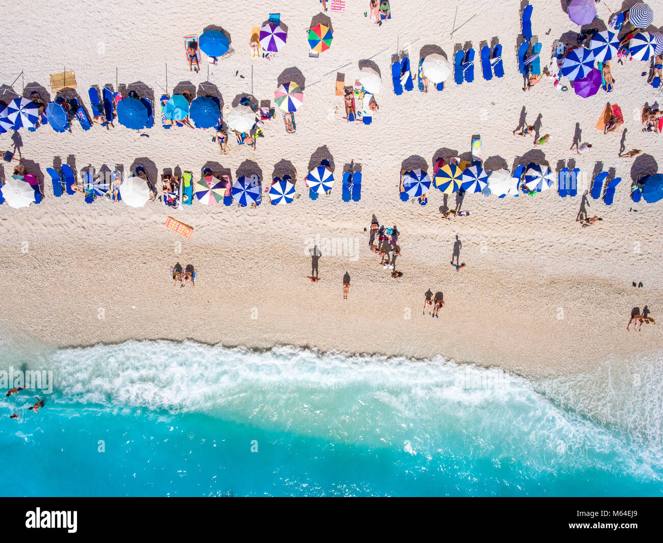 Tourists relaxing on the Egremni Beach in Lefkada swimming and playing games in the water Stock Photo