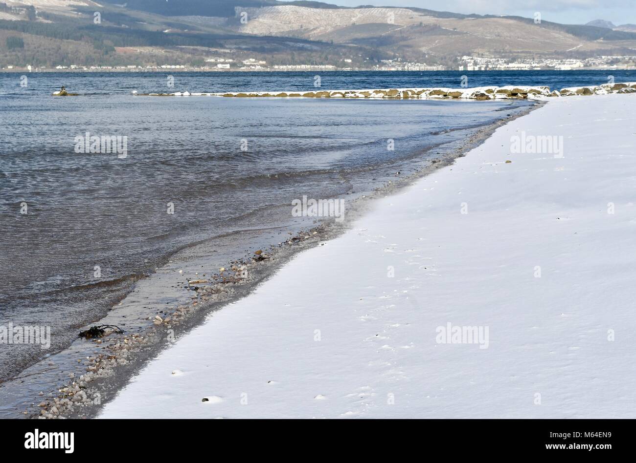 Snow covered Inverkip beach with Lairds Dyke sea defence Stock Photo