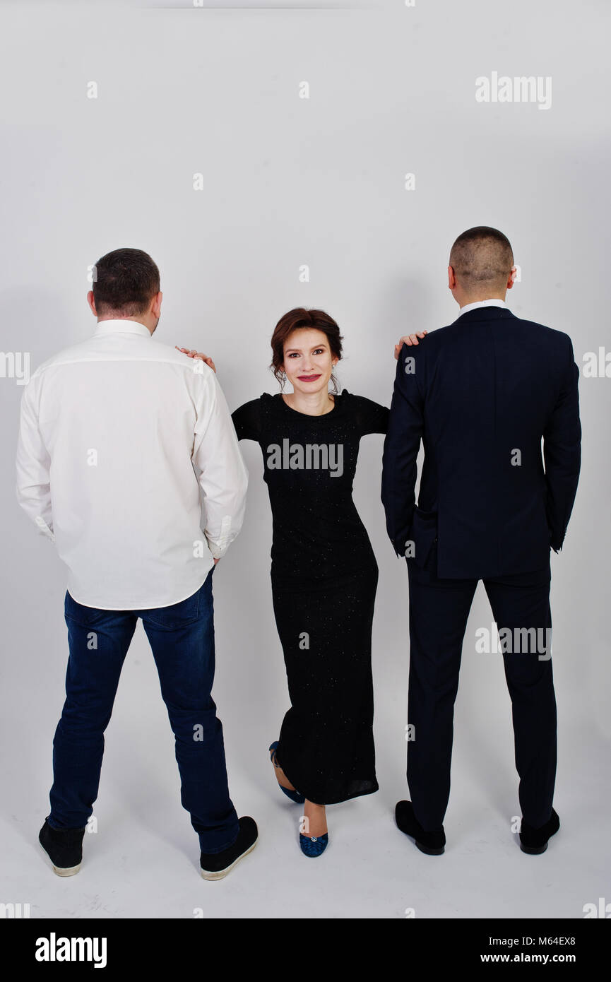 Elegance woman in black evening dress with two man in suit posed on ...