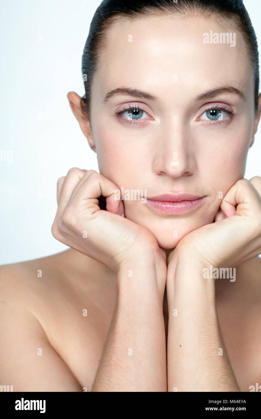 Woman with hands under chin Stock Photo