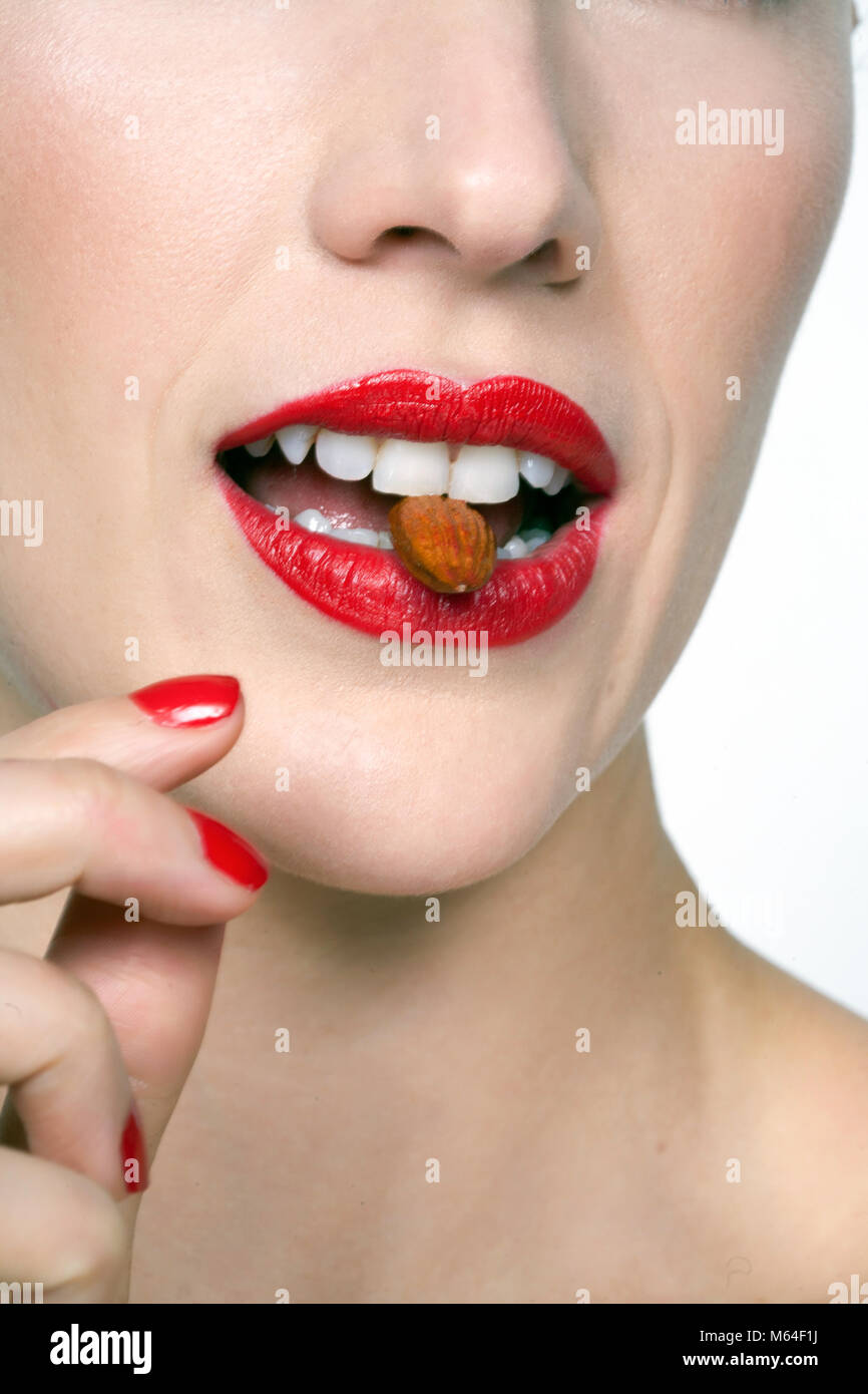 Woman's mouth with almond Stock Photo