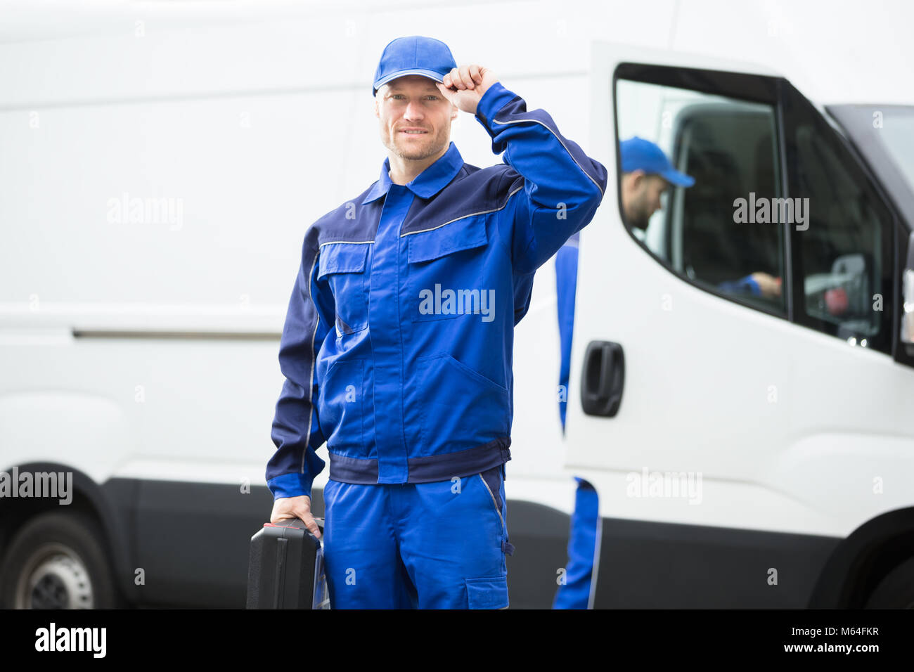 Male worker in blue uniform hi-res stock photography and images - Alamy