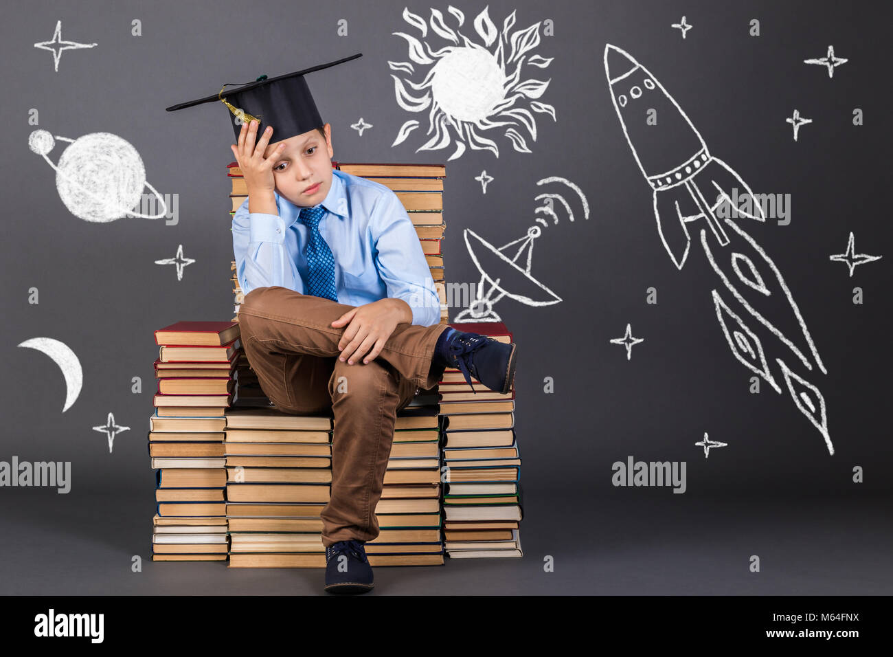 Education concept. Boy dreaming of space travel and distant planets Stock Photo