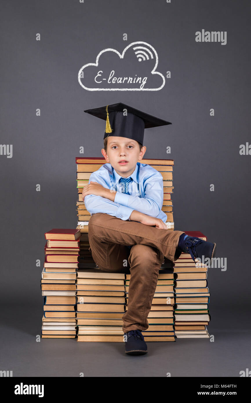 E-Learning funny education concept with boy sitting on the throne from books Stock Photo