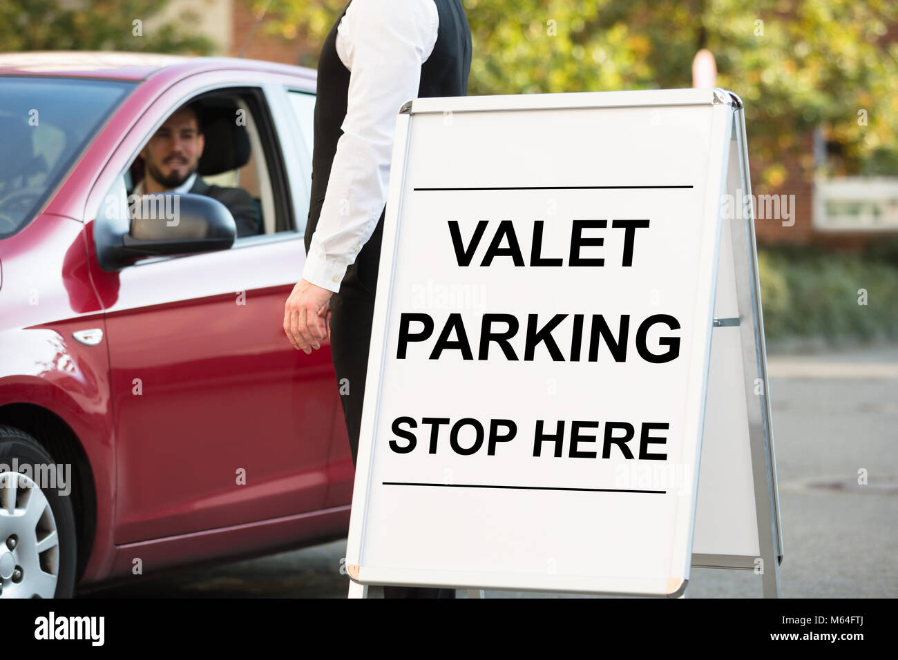 Valet Parking Text On Board In Front Of Valet Standing Near