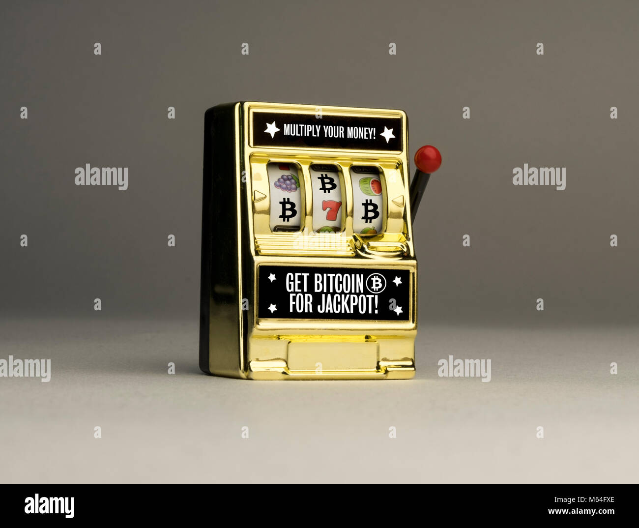 Conceptual casino slot machine to emphasise the reality of cryptocurrency Bitcoin gambling risks, one armed bandit Stock Photo