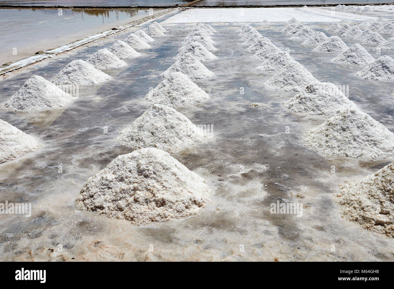 Pictures & images of Men collecting and digging salt in a salt pan on the outskirts of Trapani, Sicily Stock Photo