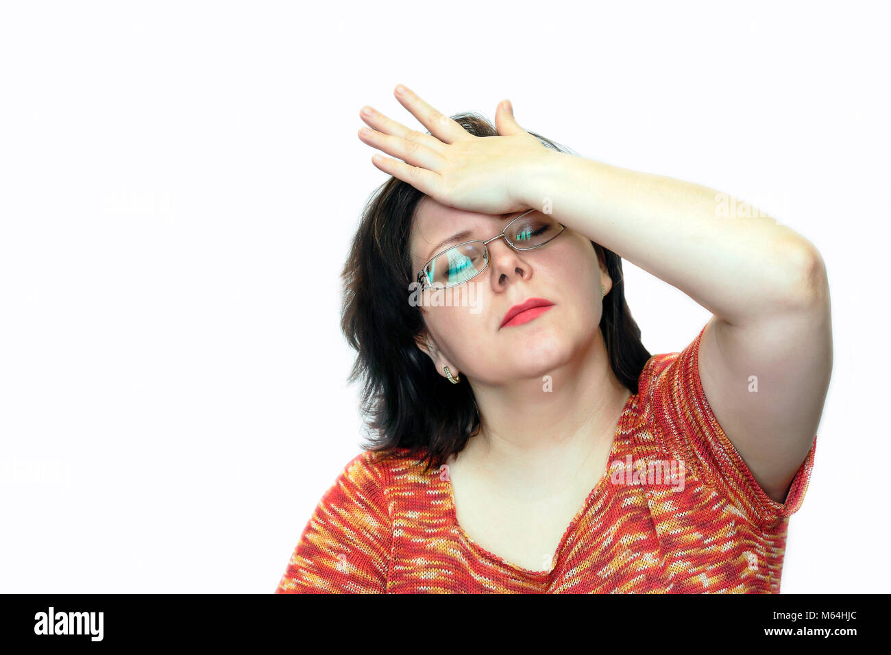 A woman holds her head in her hand. Headache. Stock Photo