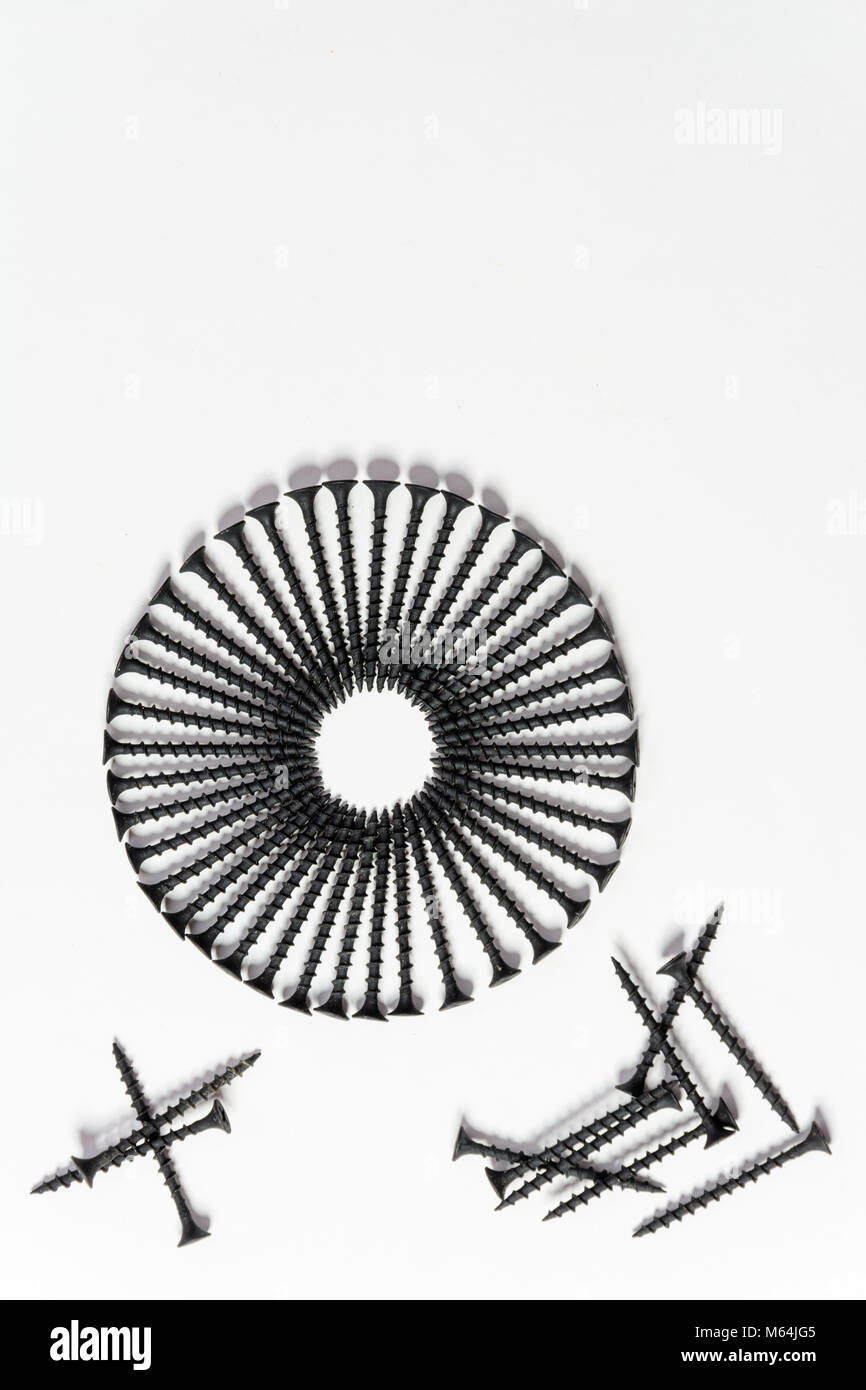 Photoset patterns arranged from black screws isolated on a white background in the form of a circle and a heart Stock Photo