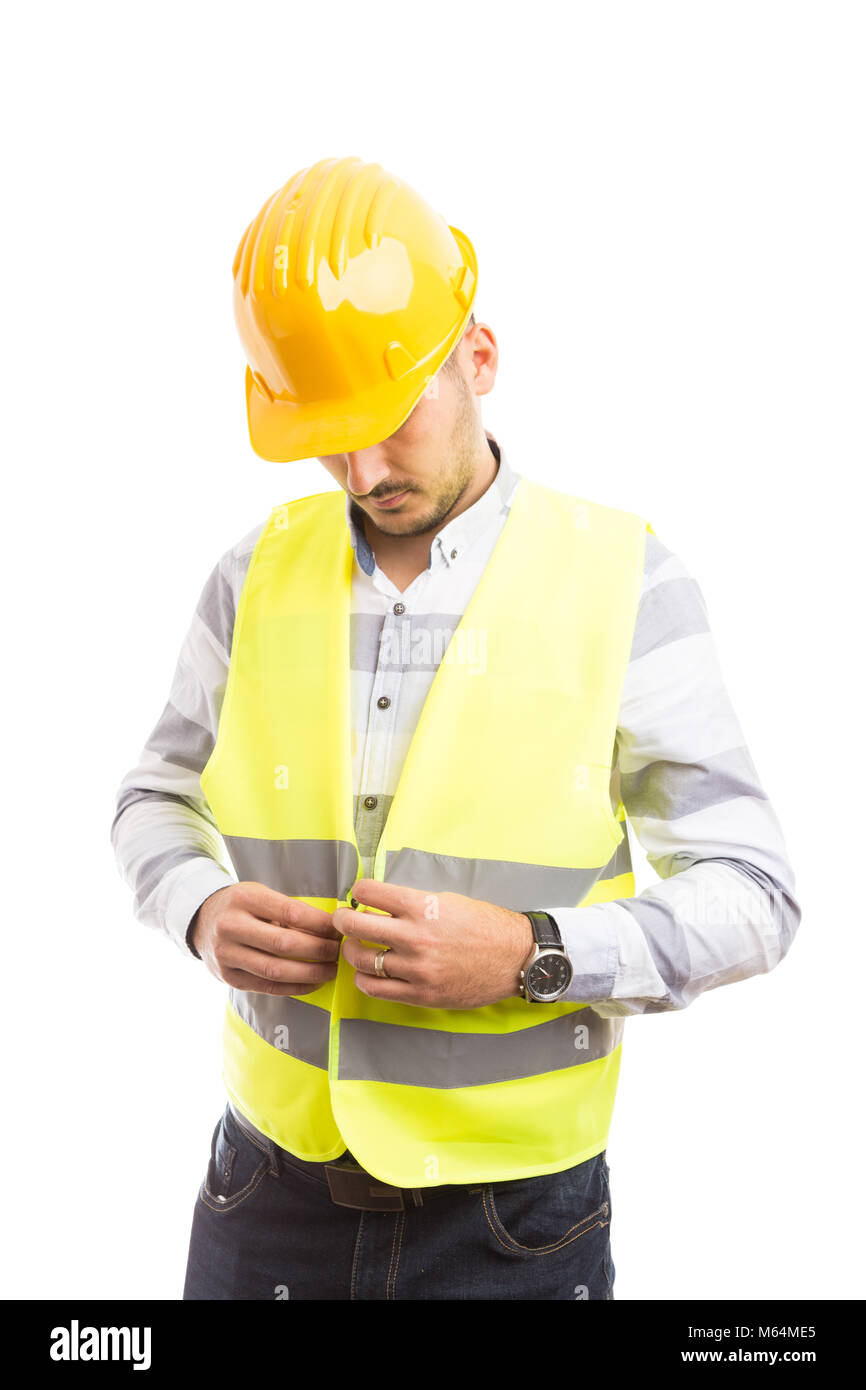 Construction worker or builder dressing for job with green reflective
