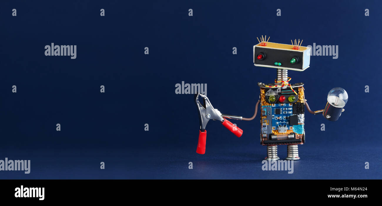 Robot serviceman red pliers light bulb on dark blue background, copy space Stock Photo