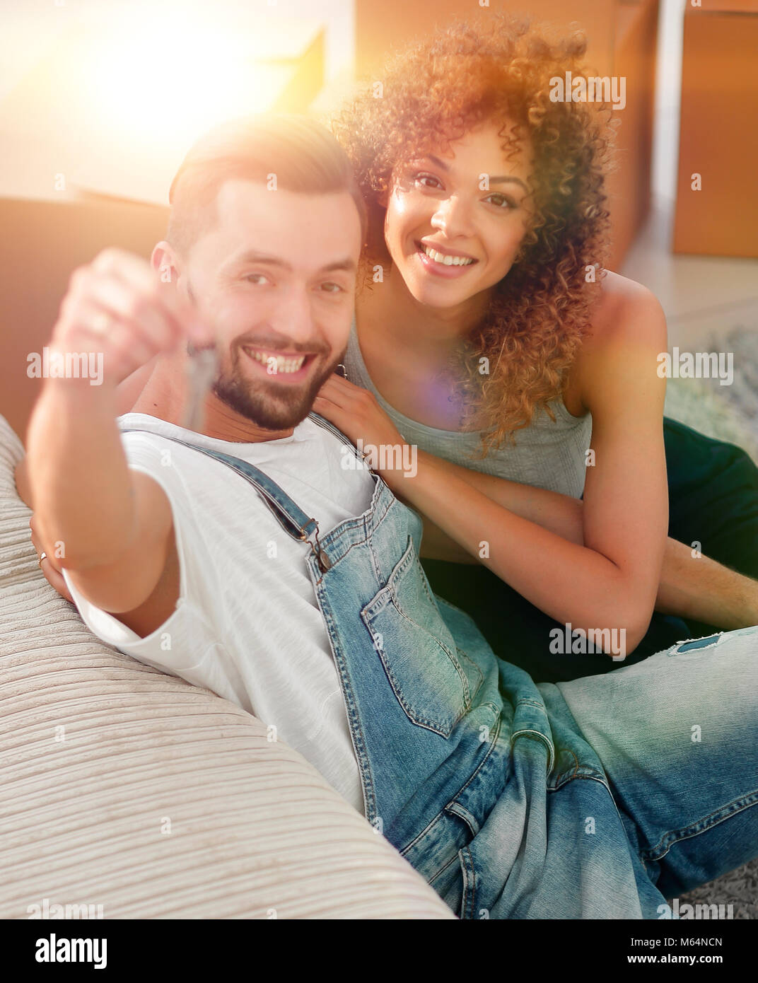 young couple holding the key to a new apartment Stock Photo - Alamy