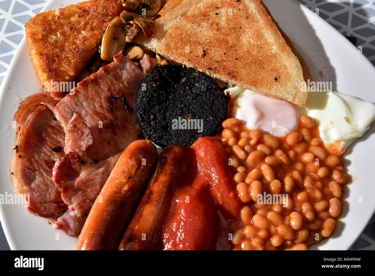 Full English Breakfast comprising of bacon, sausages, baked beans, hash