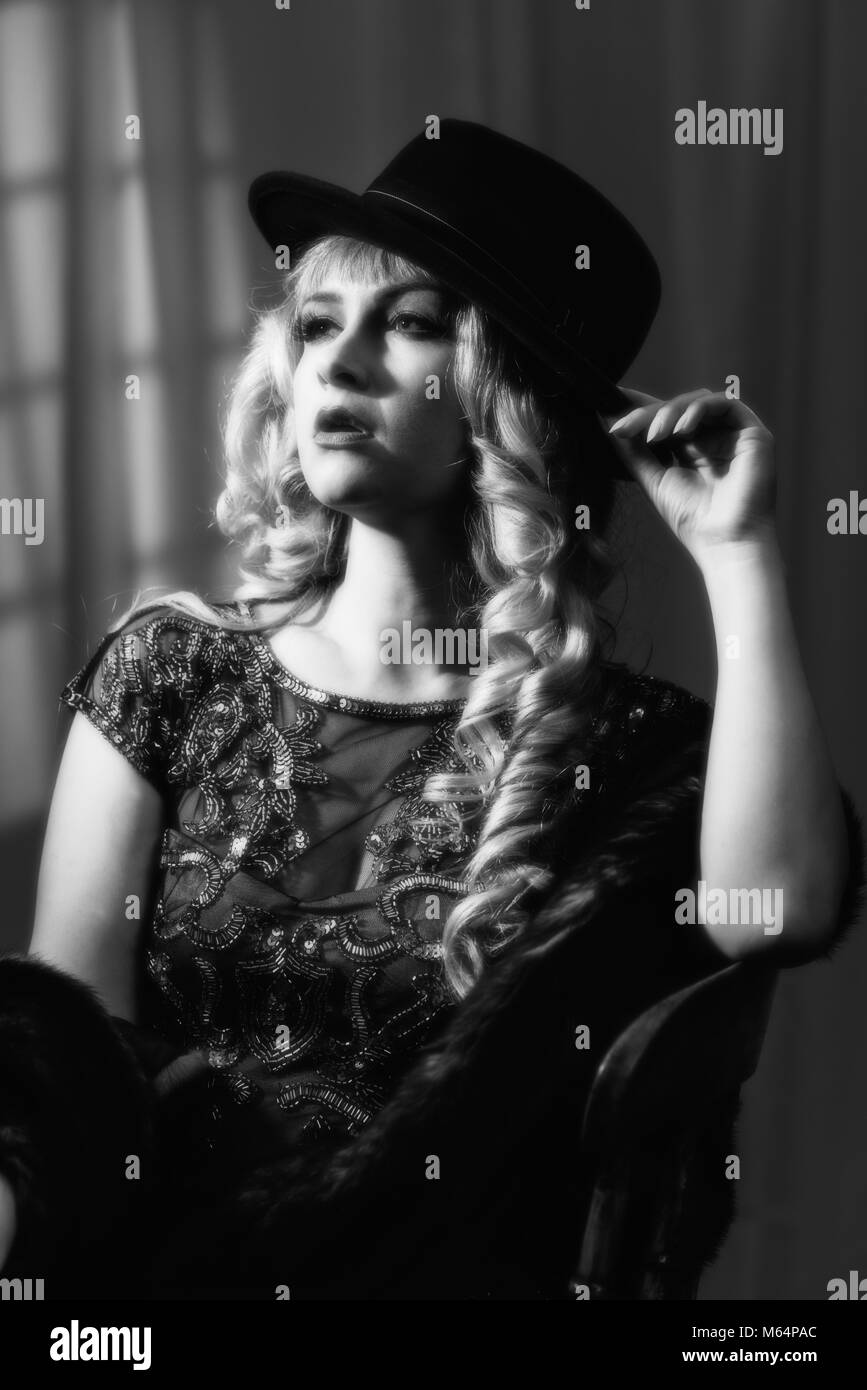 Film Noir style image of woman wearing a trilby hat Stock Photo