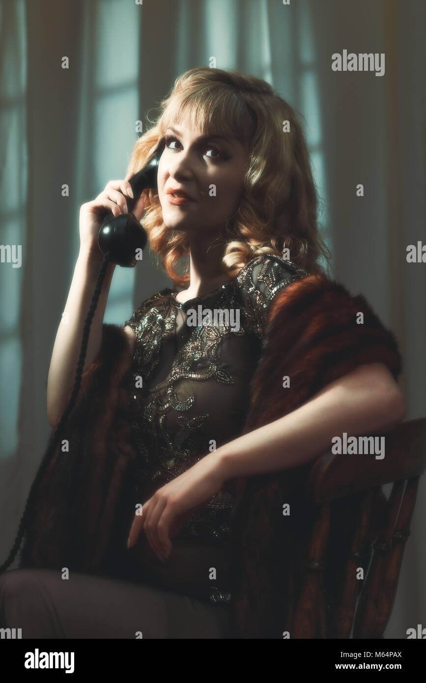 Portrait of woman on vintage telephone with cinematic style tone Stock Photo
