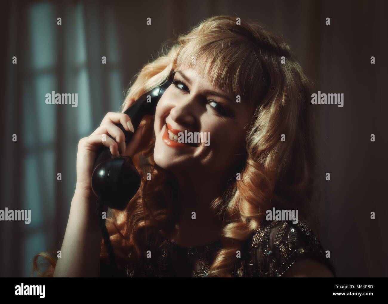 Portrait of woman in vintage style clothing on telephone Stock Photo