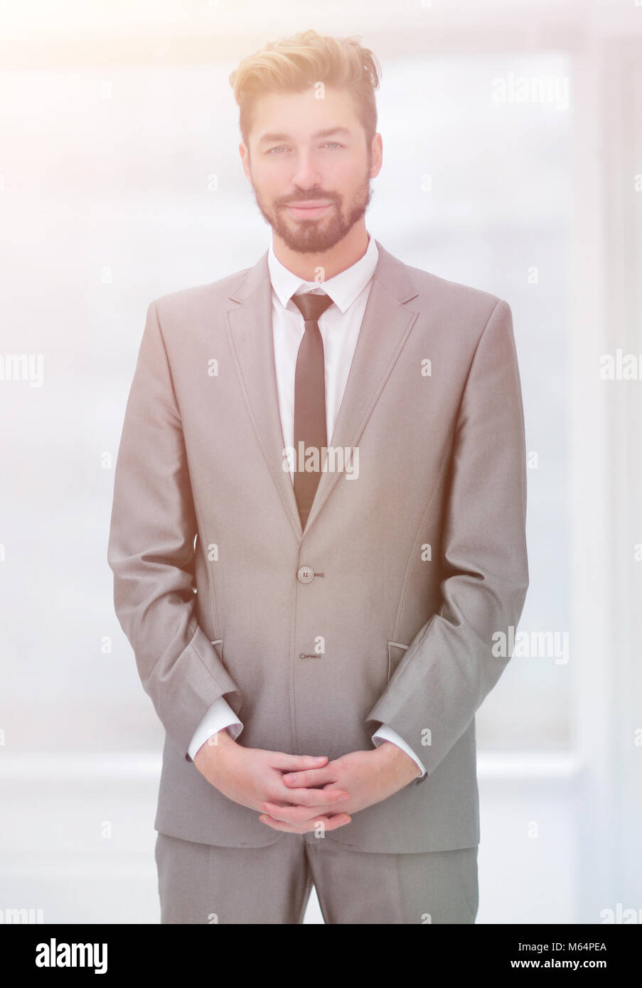 A young man in a gray suit Stock Photo - Alamy