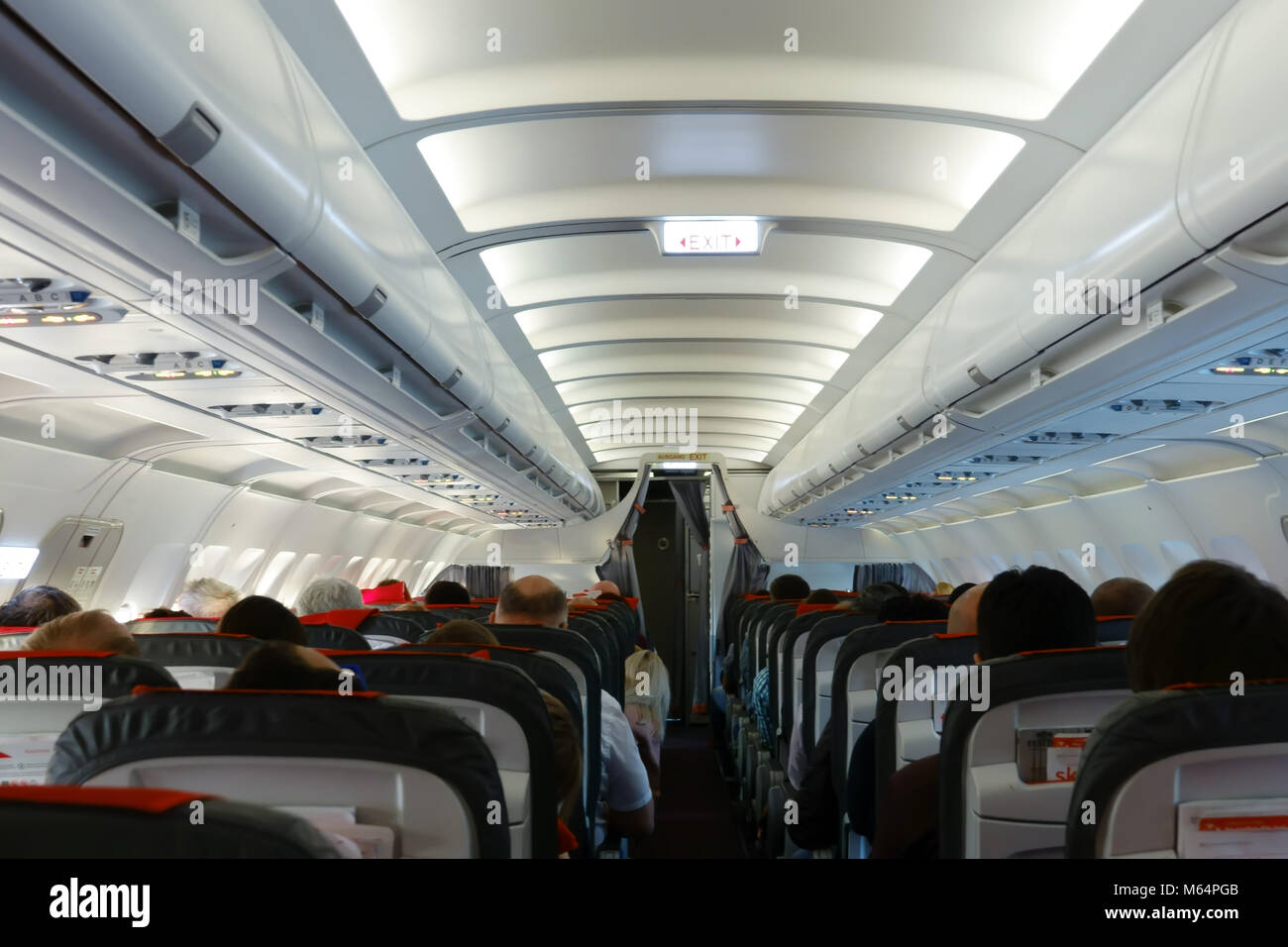 Passenger cabin in flight with people. Economy class. View from above. Stock Photo