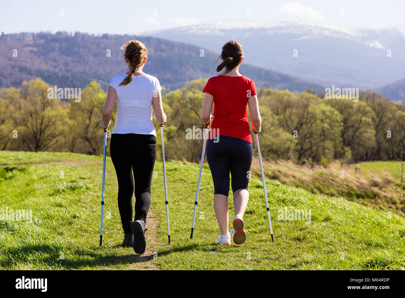 Nordic walking - active people working out outdoor Stock Photo