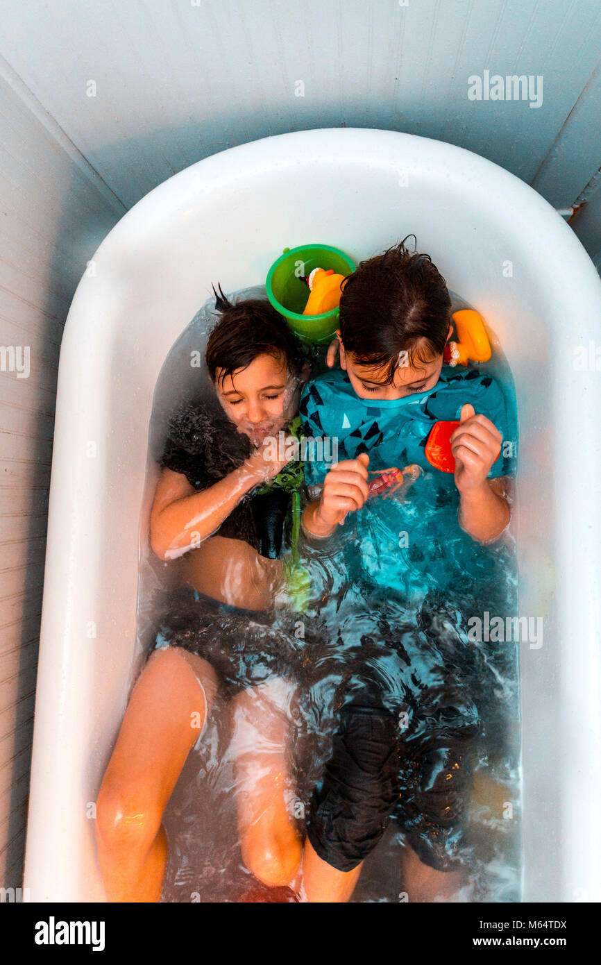 Twin Caucasian Brothers Play in Their Water Filled Bathtub Together