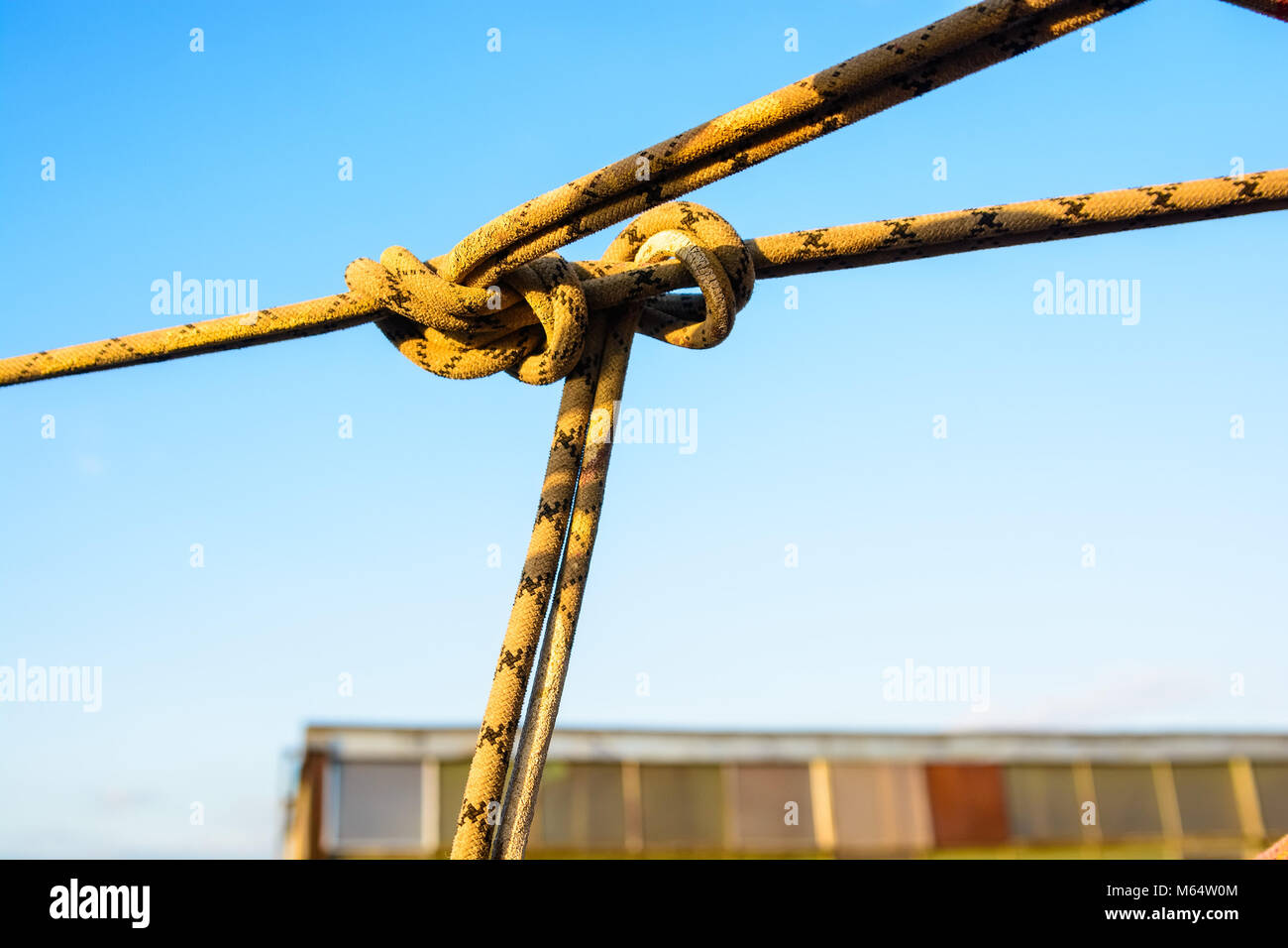 Closeup stretched and tied industrial braided rope Stock Photo - Alamy