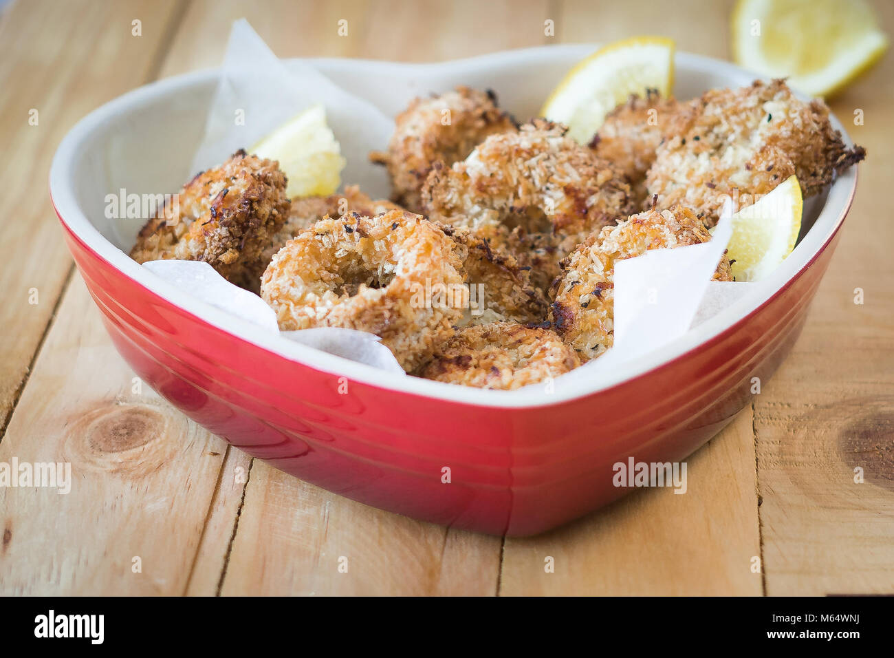 Oven baked squid (calamari) Rings in a healthy Panko & Coconut coating Stock Photo