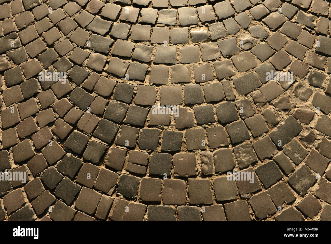 Old pavement road, texture. Texture of stone pavement tiles cobblestones, background, pavement stone. Stock Photo