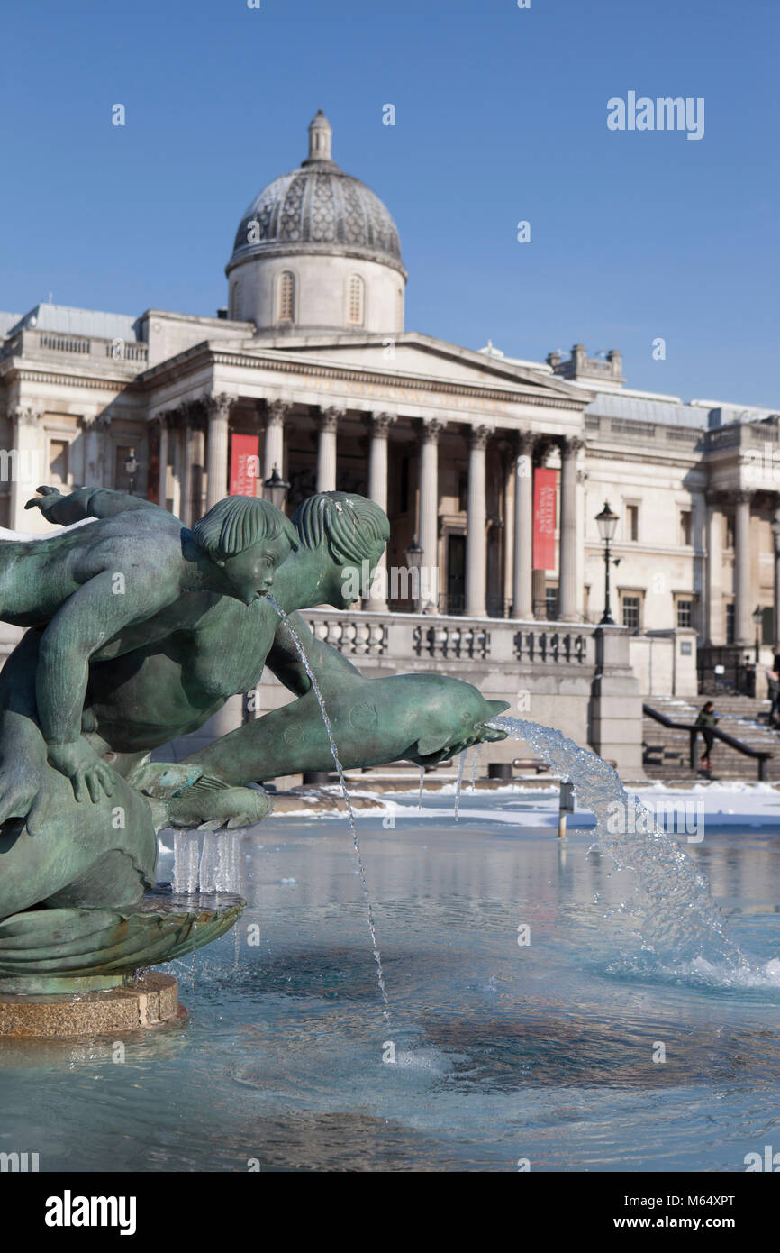 Snow on Trafalgar Square and the National Gallery and icicles on the fountains. Stock Photo