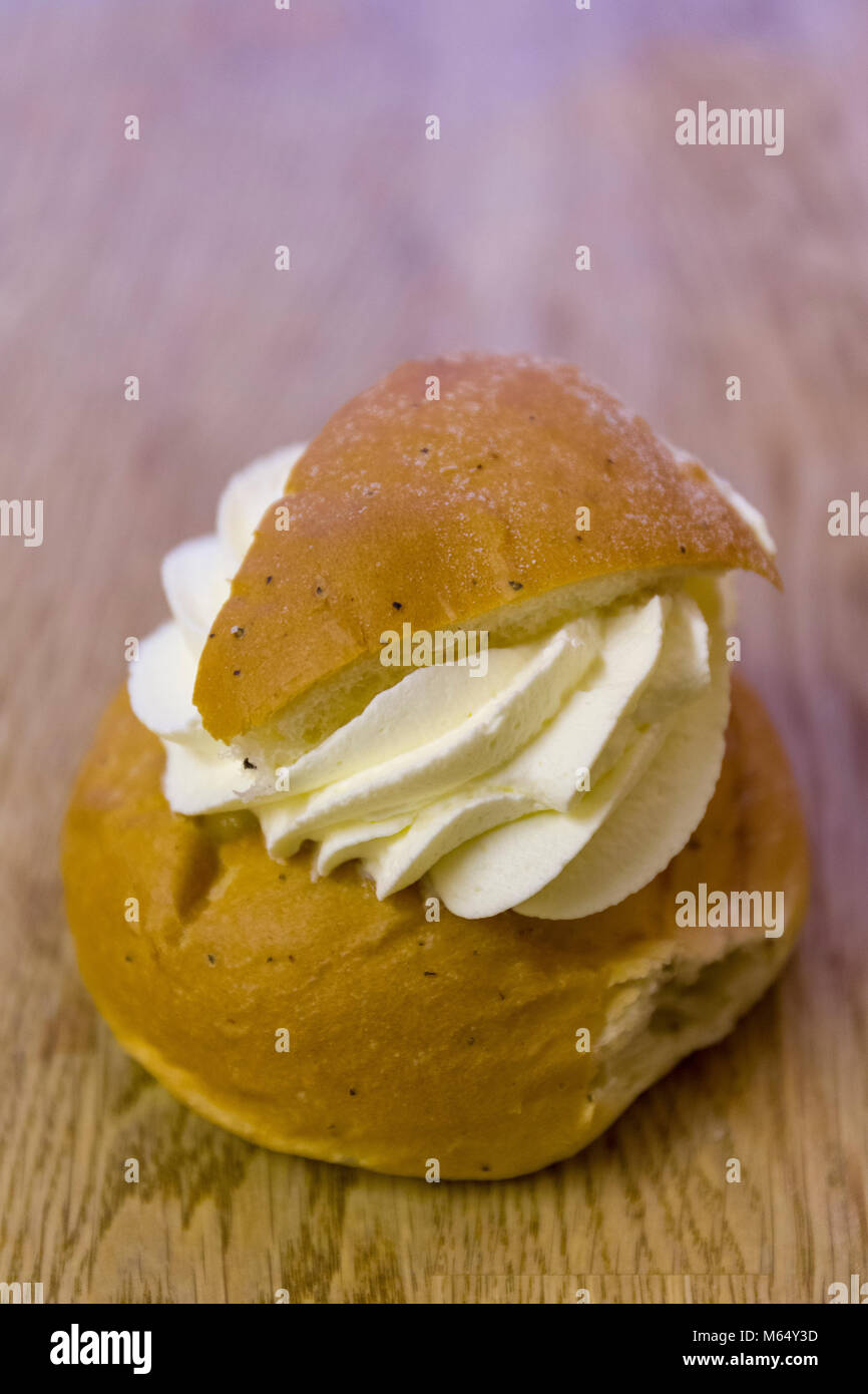 Swedish Semla – a small, wheat flour bun, flavoured with cardamom and filled with almond paste and whipped cream  Model Release: Yes/No. Property Release: Yes/No. Stock Photo