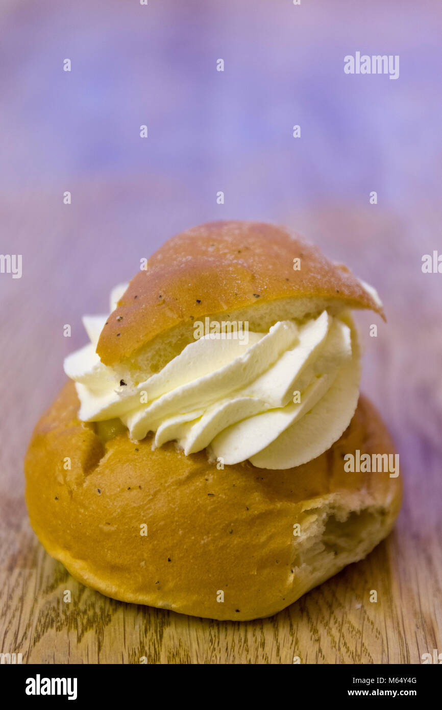Swedish Semla – a small, wheat flour bun, flavoured with cardamom and filled with almond paste and whipped cream  Model Release: Yes/No. Property Release: Yes/No. Stock Photo