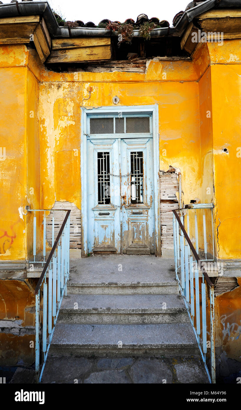 Old rustic yellow house with white door Stock Photo - Alamy