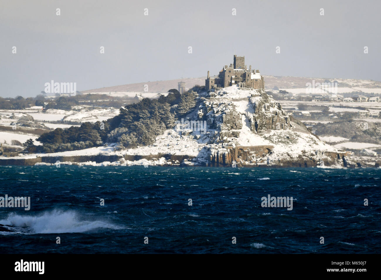 St Michael's Mount, near Marazion, Cornwall, lies covered in snow, as wintry conditions have caused more misery for travellers overnight. Stock Photo