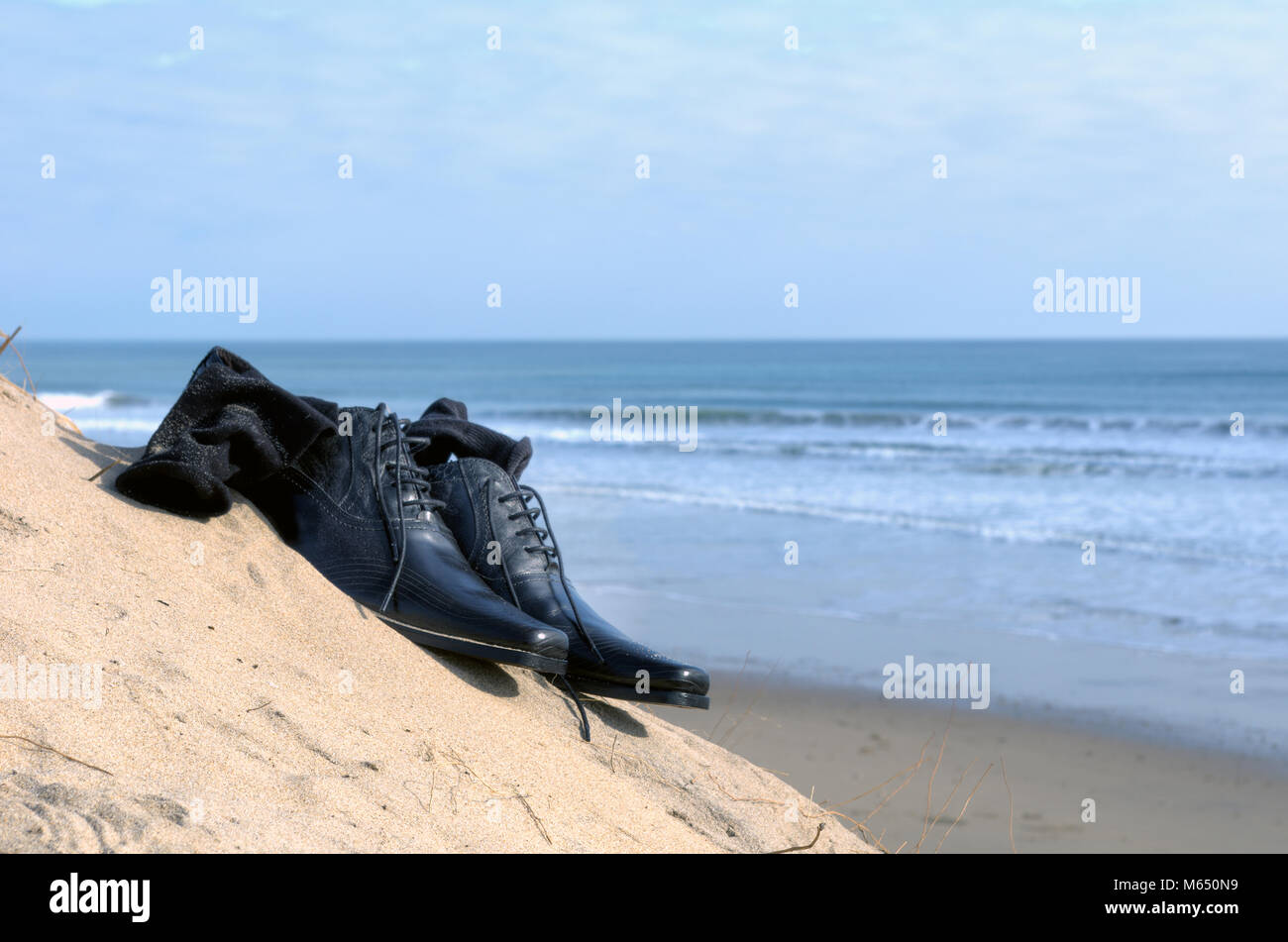 Dress shoes with sock on the beach. Business concept Stock Photo