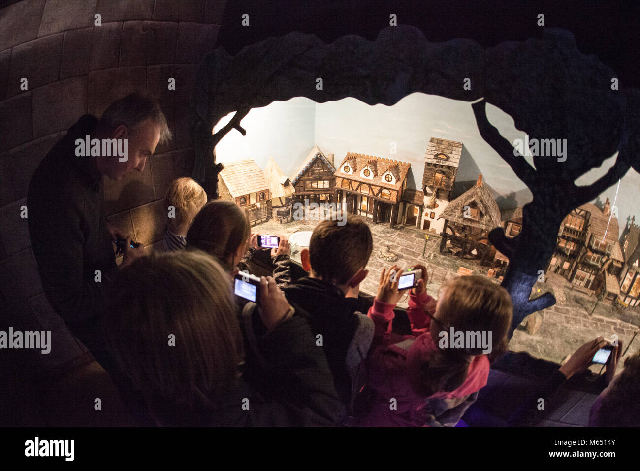 Group of young boys and girls, mixed ages at a photography lesson in a dark room at a farm Stock Photo