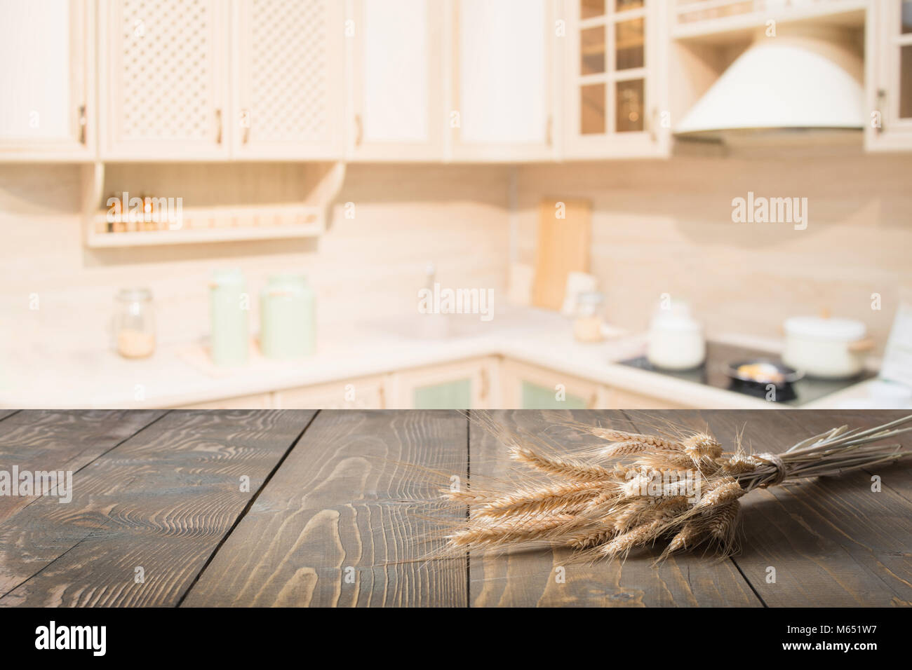 Blurred and abstract kitchen background. Wooden tabletop with wheat and