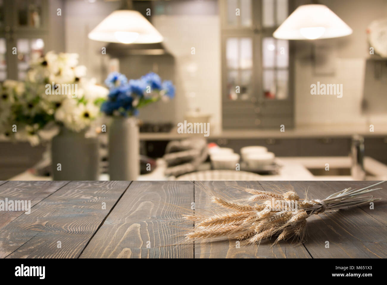 Blurred and abstract kitchen background. Wooden tabletop with wheat and