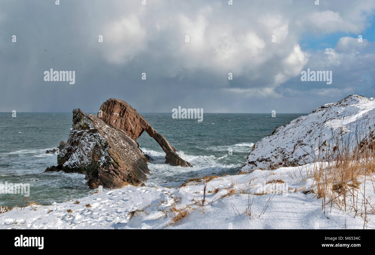 MORAY COAST SCOTLAND PORTKNOCKIE  BOW FIDDLE ROCK IN FEBRUARY WINTER STORM WITH HIGH WINDS AND SNOW Stock Photo